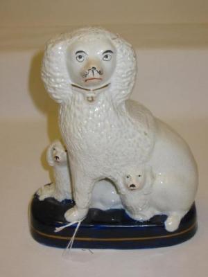 Appraisal: A STAFFORDSHIRE POTTERY FIGURE modelled as a seated poodle and