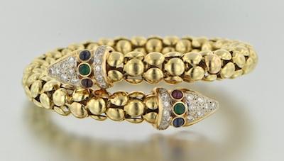 Appraisal: A Lades' K Gold Diamond Ruby Sapphire and Emerald Bangle