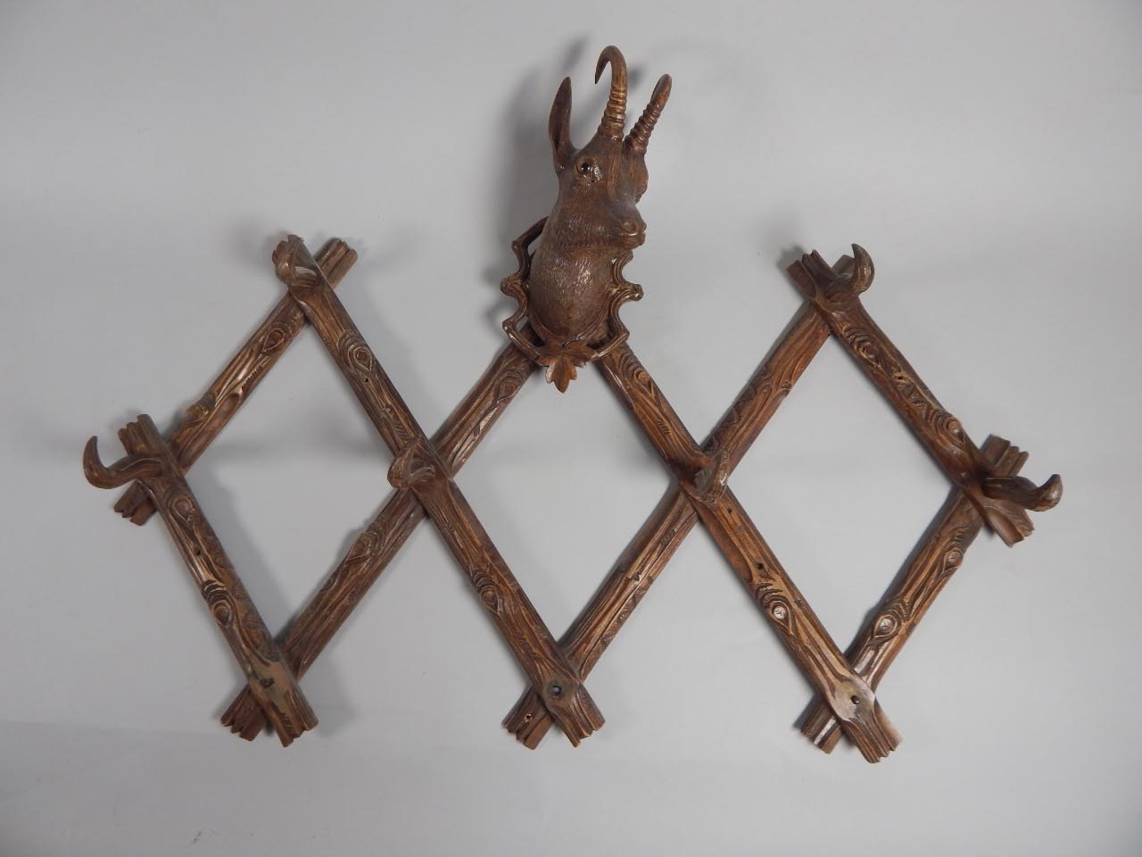 Appraisal: A Black Forest linden wood carved coat rack modelled centrally