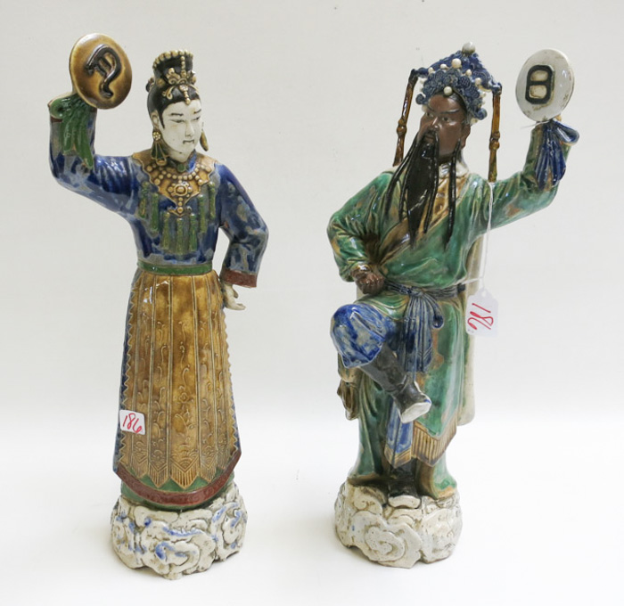 Appraisal: PAIR CHINESE POTTERY FIGURAL SCULPTURES male and female Mudmen dancers