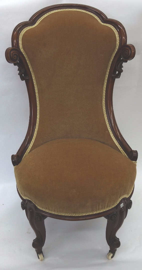 Appraisal: A Victorian carved mahogany shaped frame nursing chair with upholstered