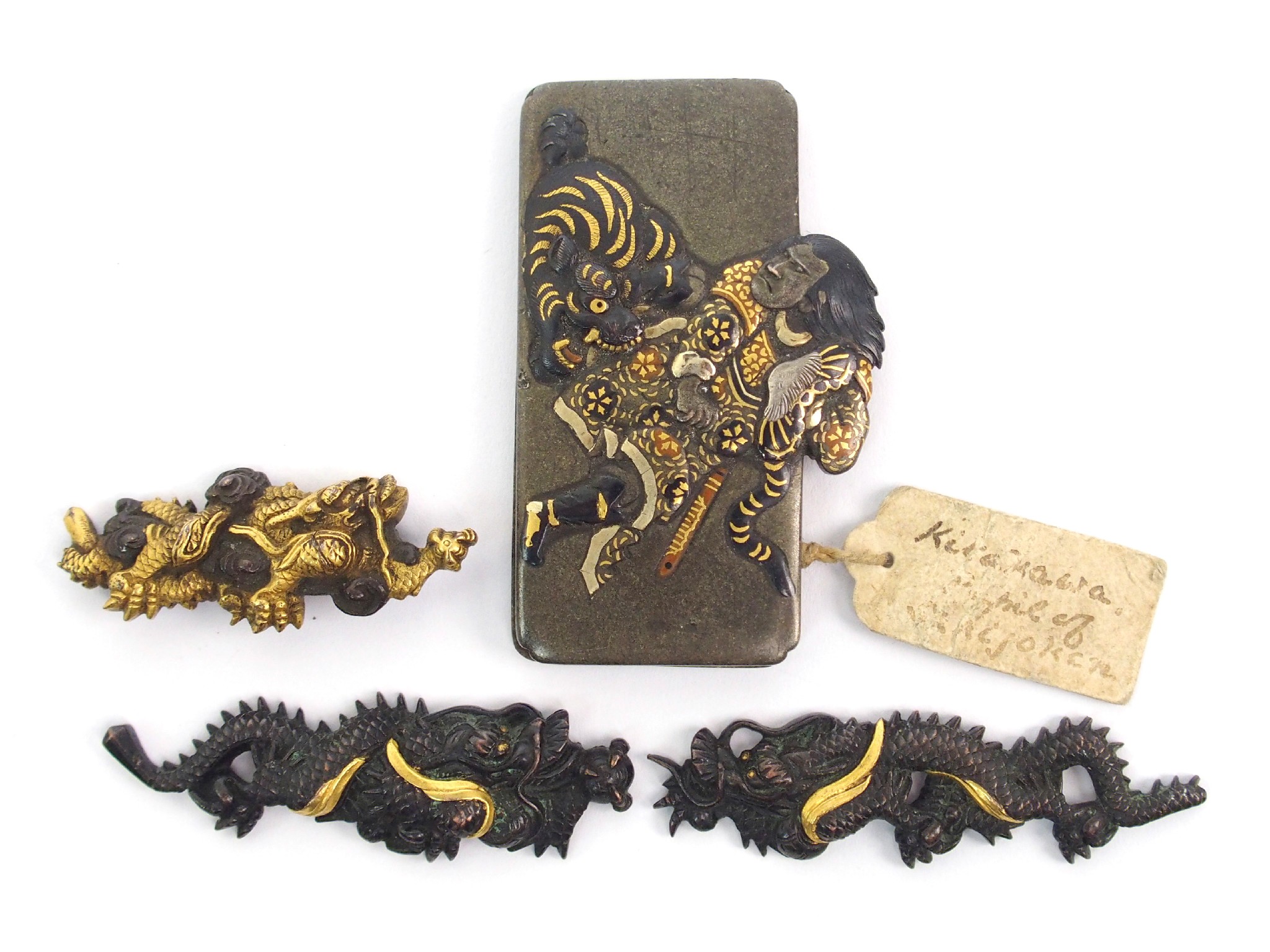 Appraisal: A Japanese bronze rectangular mountcast with a warrior in combat