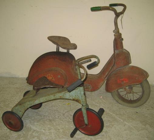 Appraisal: A Trietta childs scooter bicycle with tin plate saddle faring