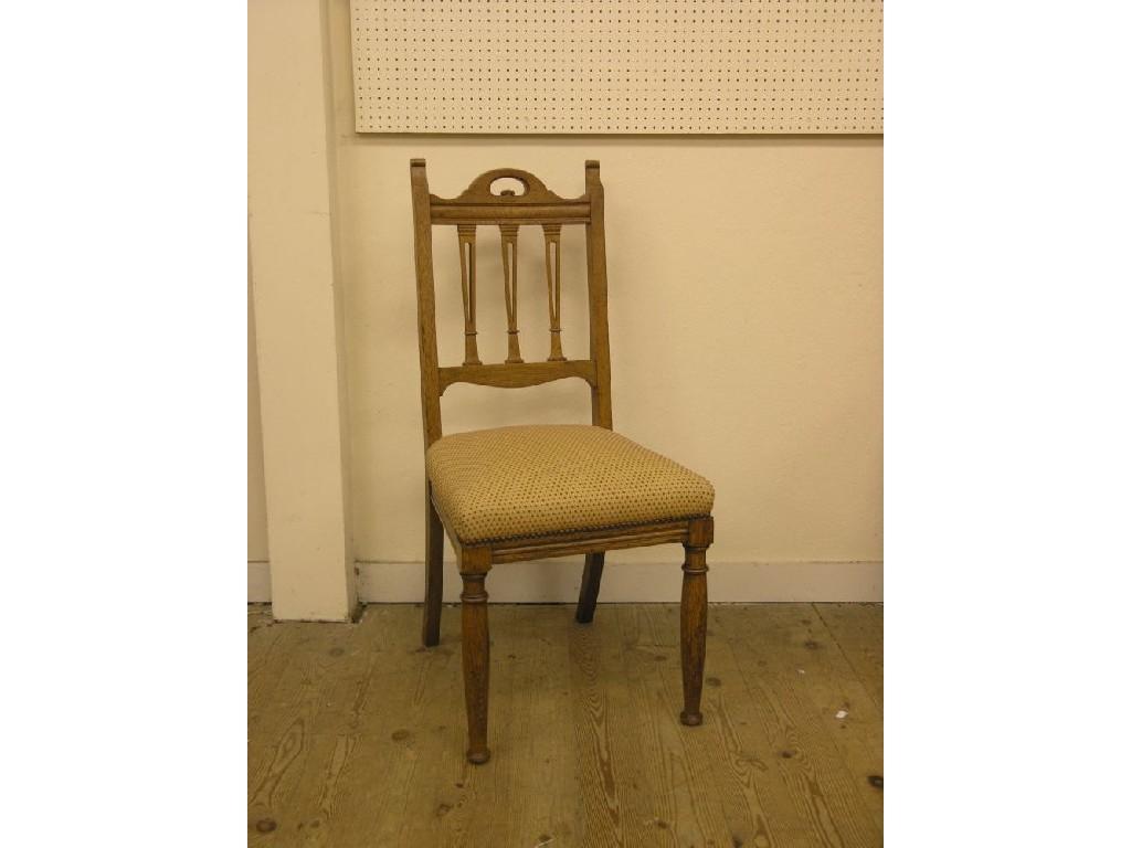 Appraisal: A set of four Edwardian light oak dining chairs pierced