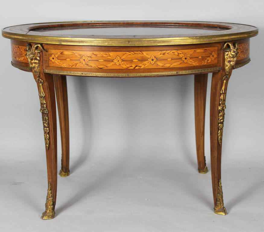 Appraisal: LOUIS XV XVI STYLE OVAL MAHOGANY MARQUETRY LOW TABLE WITH