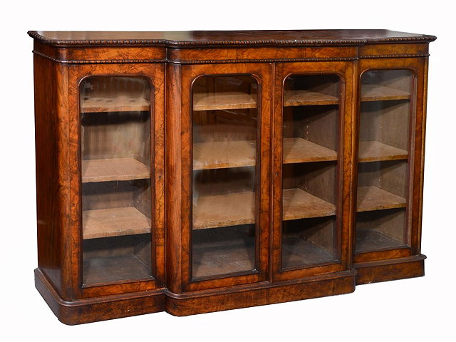 Appraisal: A TH CENTURY WALNUT BREAKFRONT BOOKCASE with beaded top border