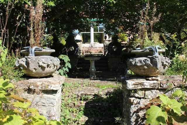 Appraisal: A PAIR OF RECONSTITUTED STONE OVOID PLANTERS with spreading rims