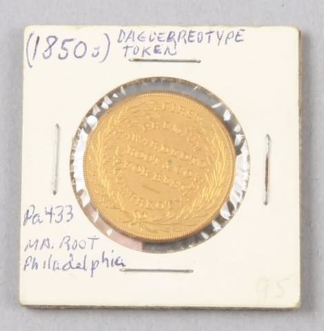 Appraisal: Gilded brass token with obverse M A Root's Daguerrian Gallery