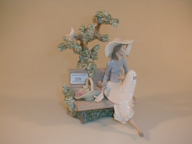 Appraisal: A Lladro figurine of a young lady with a flower