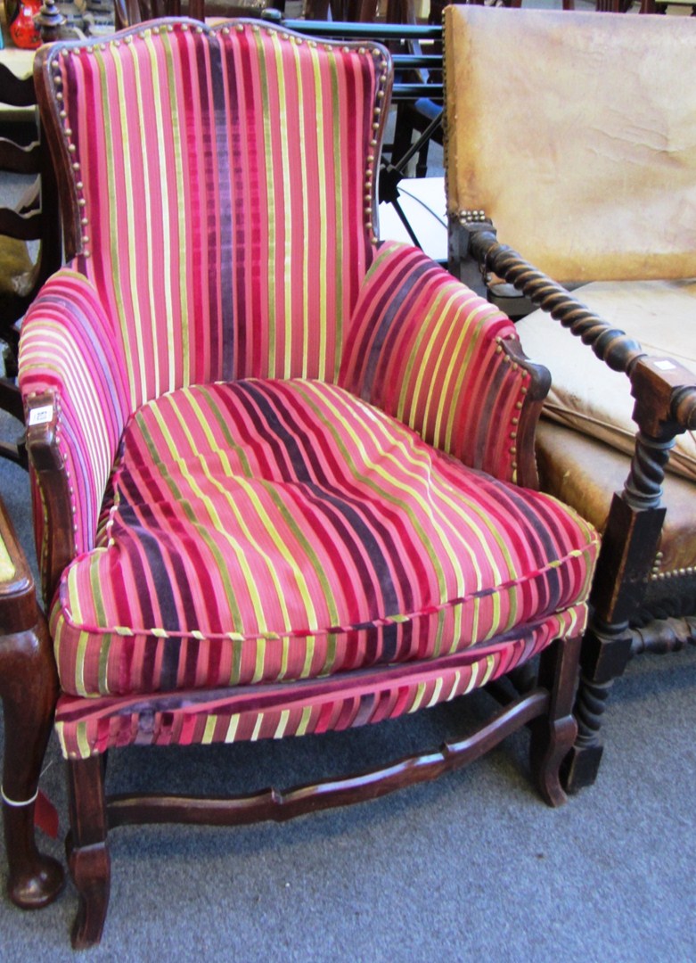 Appraisal: A pair of French stained beech framed armchairs with red