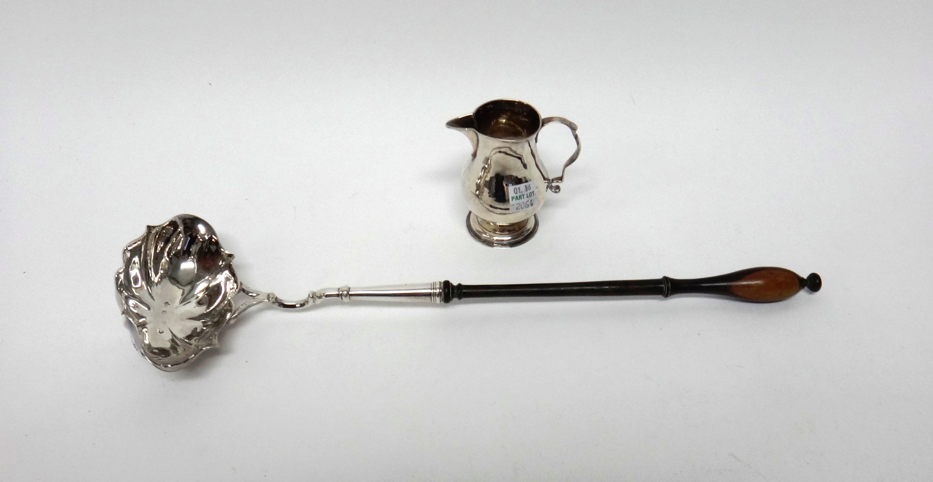 Appraisal: A silver cream jug of baluster form with a scrolling