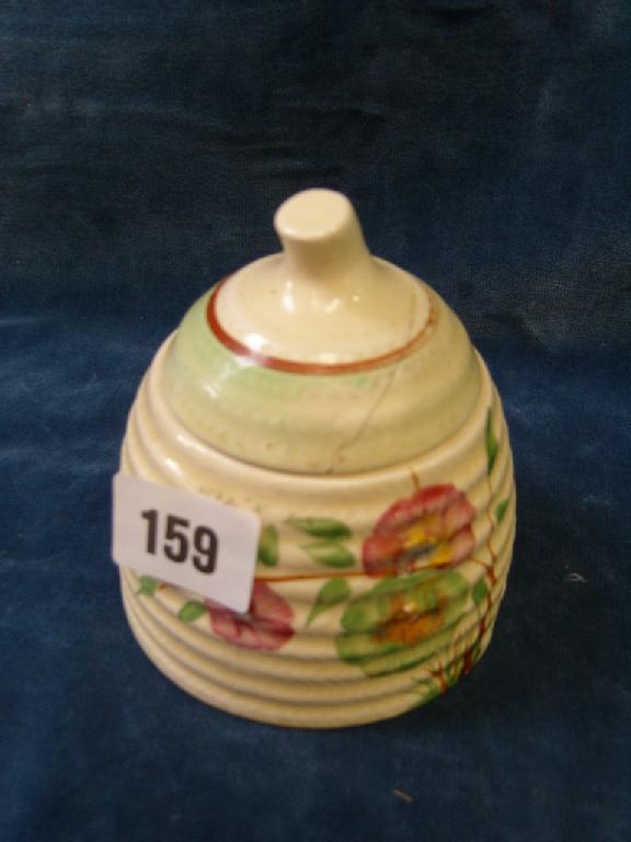 Appraisal: A Clarice Cliff honey pot and cover with moulded rope