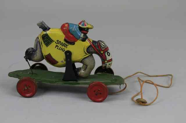 Appraisal: SUNSHINE RIDING SPARKPLUG Lithographed tin pull toy probably made by