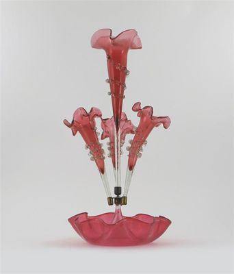 Appraisal: A cranberry glass pergne with four trumpets rising from a