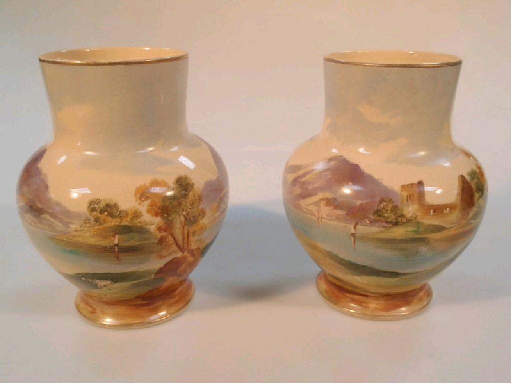 Appraisal: A pair of pottery baluster vases each painted with extensive