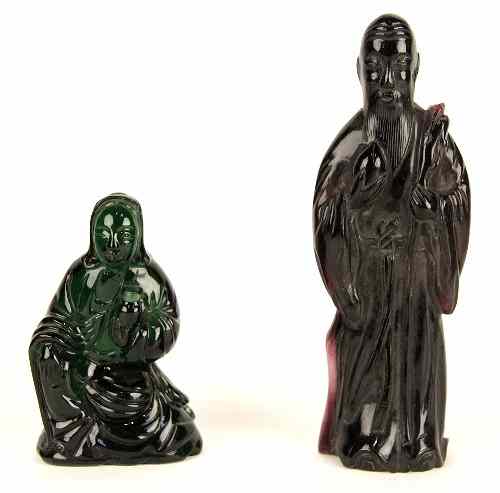 Appraisal: A green glass figure seated with Chinese character marks beneath