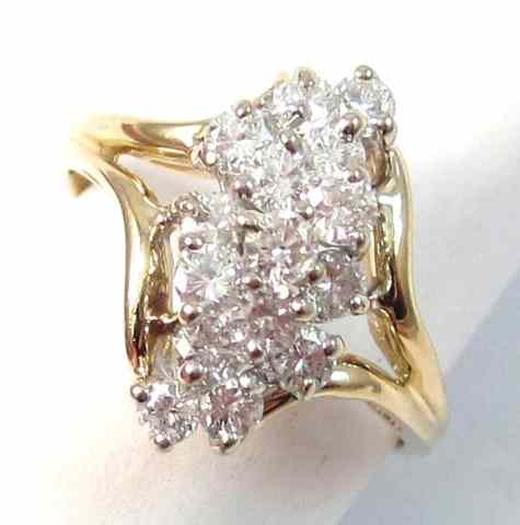 Appraisal: DIAMOND AND FOURTEEN KARAT GOLD RING set with a cluster