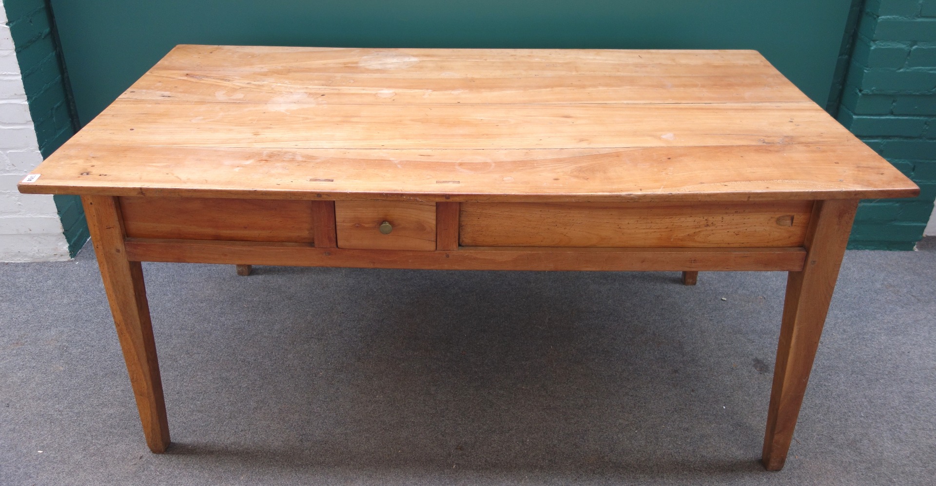 Appraisal: A th century French cherry wood kitchen table the frieze