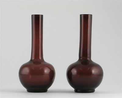 Appraisal: A pair of Chinese Beijing amethyst coloured glass bottle vases