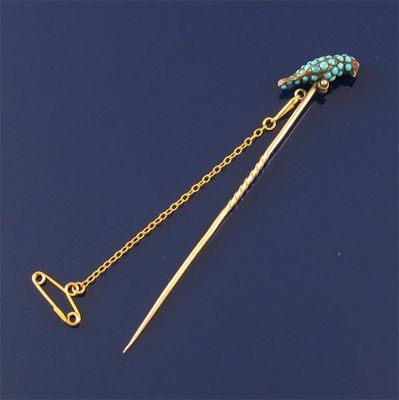 Appraisal: A gold stick pin with parrot Set with turquoise cabochons