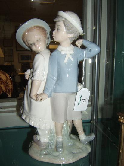 Appraisal: A Lladro figure of a boy and girl holding hands