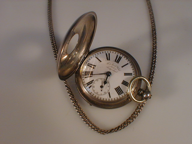 Appraisal: A silver half hunter pocket watch and Albert