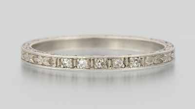 Appraisal: A Platinum and Diamond Band Platinum band engraved on top