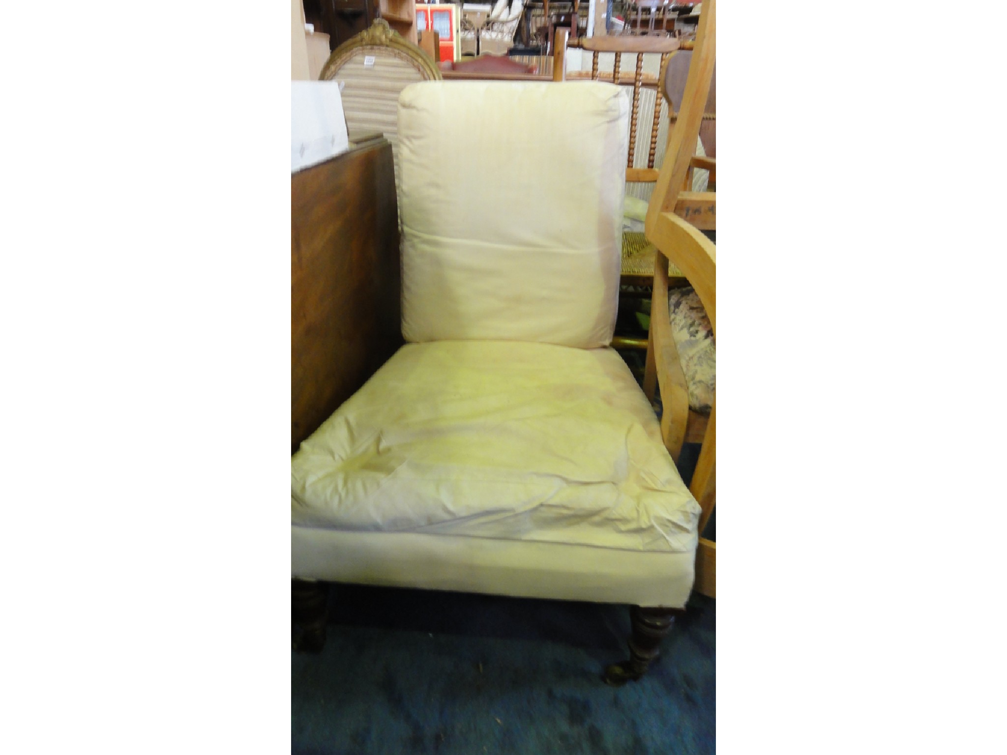 Appraisal: A Victorian nursing chair simply upholstered in white calico raised