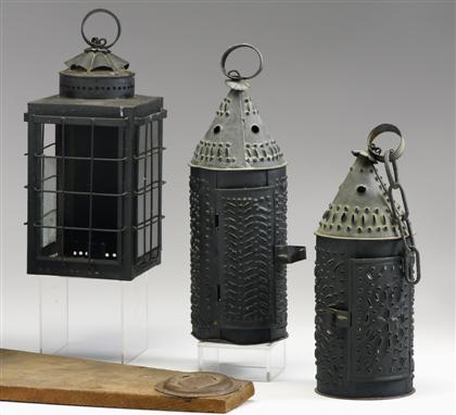 Appraisal: Three tin candle lanterns early th century Two cylindrical punched-tin