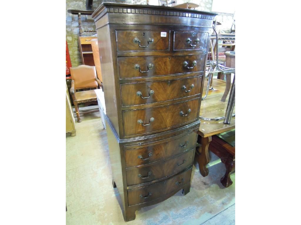 Appraisal: A reproduction mahogany tallboy in the Georgian style bow fronted