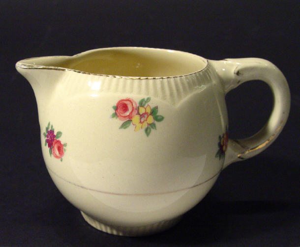 Appraisal: Clarice Cliff pottery cream jug decorated with floral sprigs factory