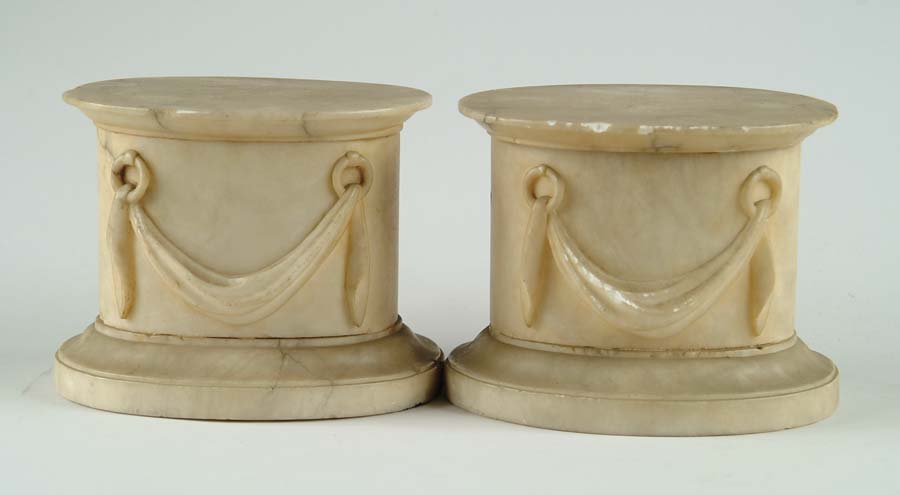 Appraisal: PAIR OF OVAL ALABASTER PEDESTALS Oval form with carved curtain