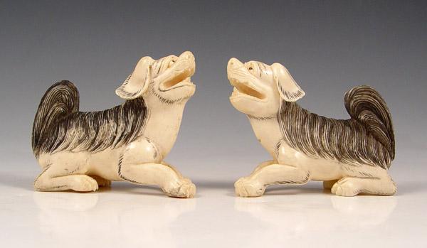 Appraisal: PAIR CHINESE CARVED IVORY FOO DOGS Pair mirror image of