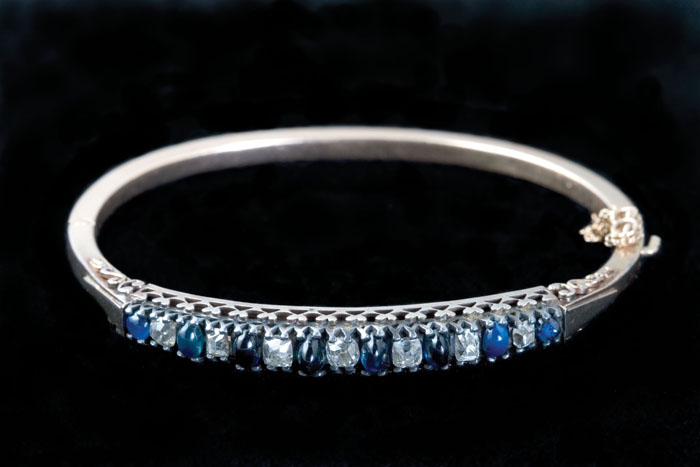 Appraisal: CABOCHON-CUT SAPPHIRE DIAMOND GOLD AND SILVER BANGLE BRACELET The bangle