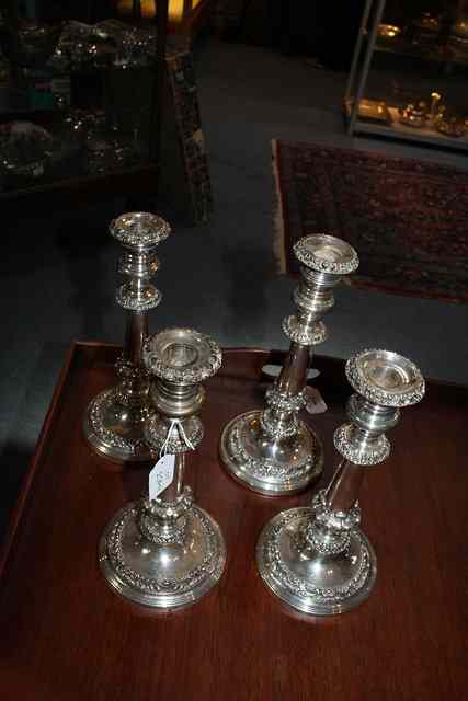 Appraisal: A SET OF FOUR SILVER PLATED CANDLESTICKS on turned stepped