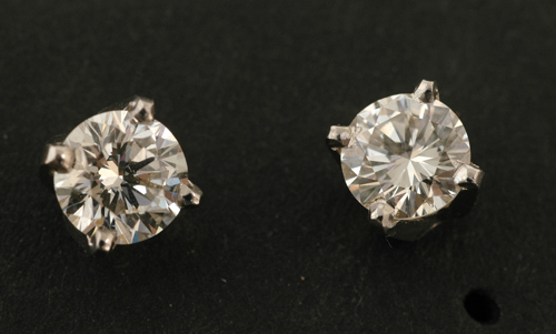 Appraisal: A pair of diamond earrings Each set with a round