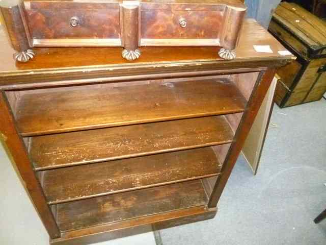 Appraisal: A MAHOGANY DWARF BOOKCASE enclosing four adjustable shelves standing on