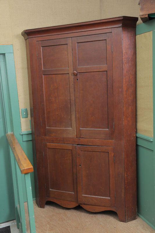 Appraisal: CORNER CUPBOARD Cherry with two sets of blind doors shaped