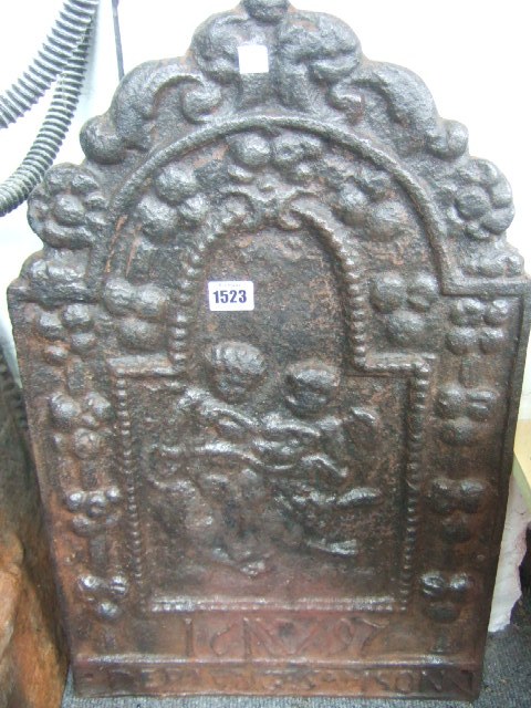 Appraisal: A cast iron fire back th century relief moulded with