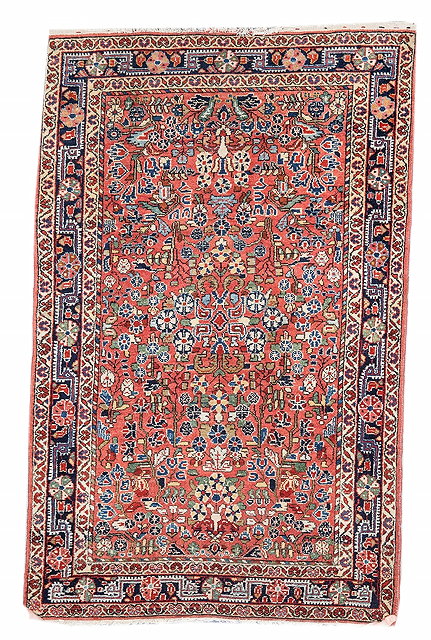 Appraisal: A JOSAN PASTEL RED GROUND RUG with intense polychrome foliate