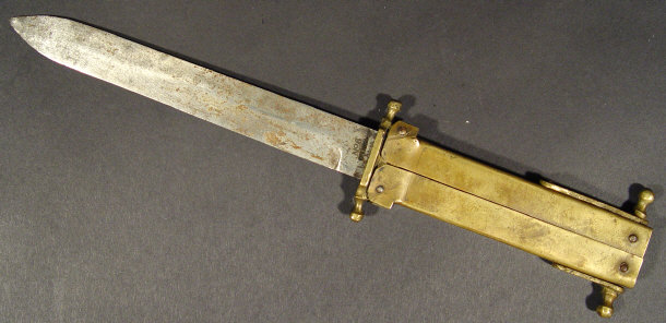 Appraisal: Steel bladed folding brass military fighting knife