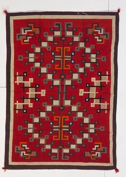 Appraisal: A Navajo rug Aligning interlaced diamonds central cruciform motifs flanked