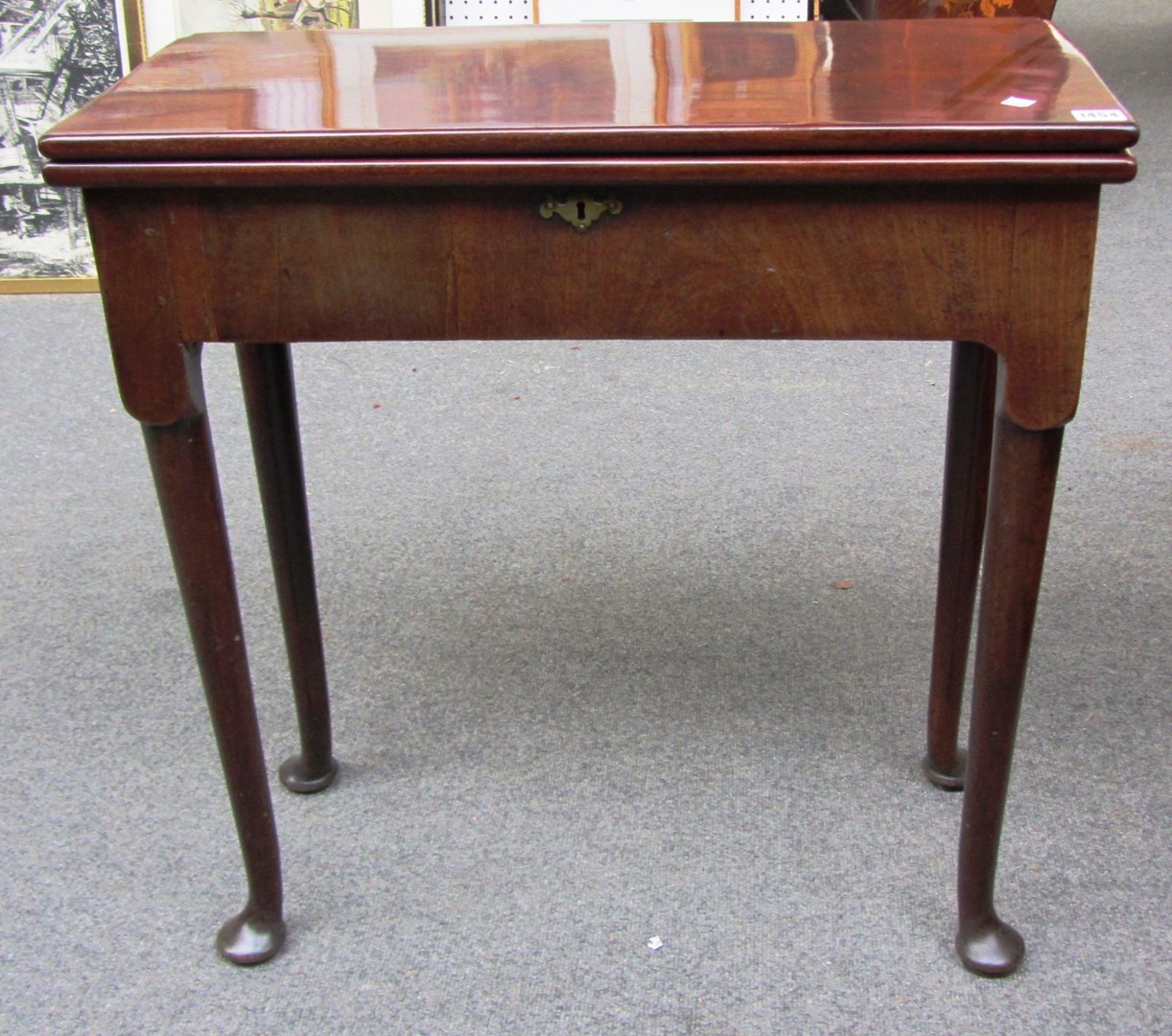 Appraisal: A George II mahogany tea table on turned supports and