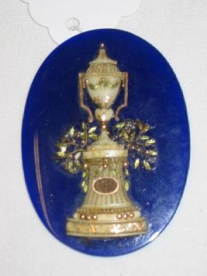 Appraisal: A GEORGIAN BLUE GLASS MEMORIAL PANEL of oval form applied