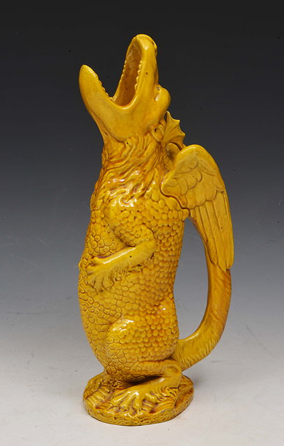 Appraisal: A Burmantofts grotesque dragon jug shape no in amber glaze