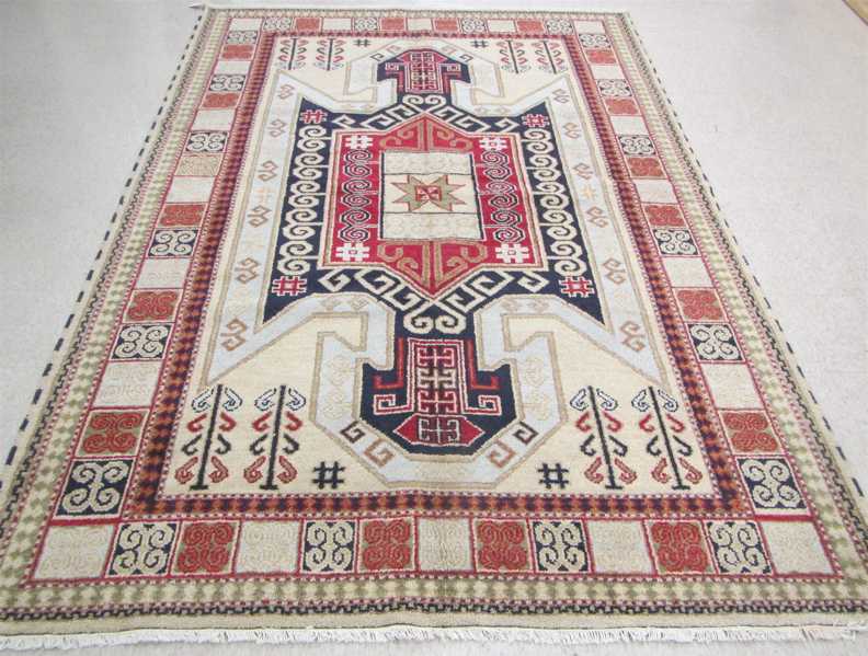 Appraisal: HAND KNOTTED ORIENTAL CARPET Indo-Kazak central geometric medallion design on