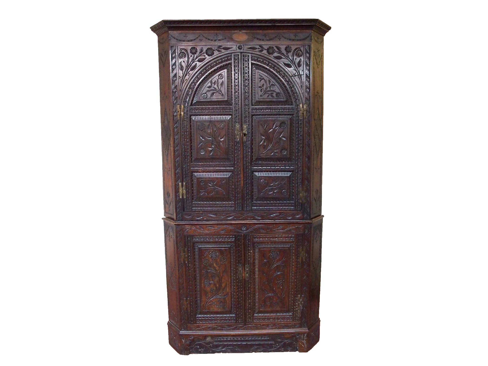 Appraisal: A Dutch oak carved corner cupboard and basedecorated allover with