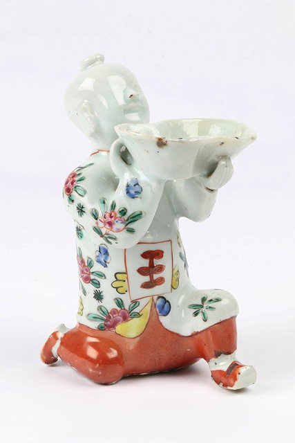 Appraisal: A JAPANESE PORCELAIN FIGURE of a boy kneeling with a