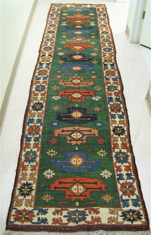 Appraisal: AFGHANI TRIBAL RUNNER overall repeating geometric design on green ground