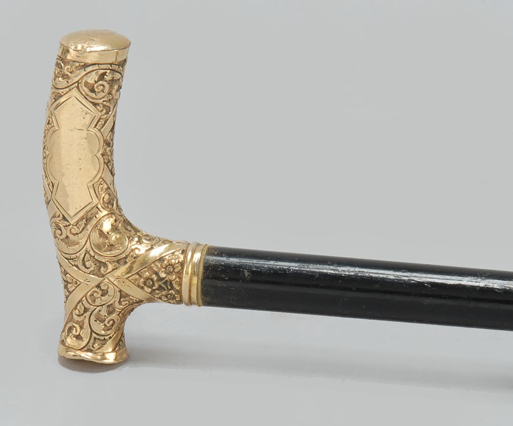 Appraisal: GOLD-HANDLED CANE th CenturyEngraved foliate design to handle Ebonized shaft